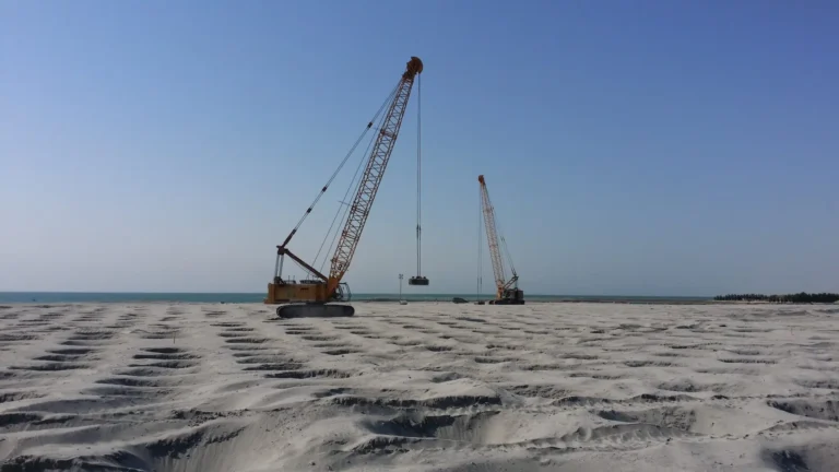 Construction site at Sheikh Jaber Bridge with heavy machinery.