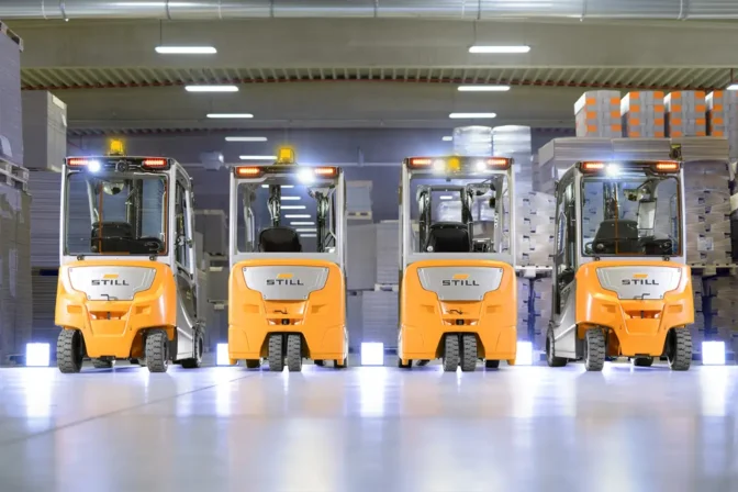 Fleet of construction vehicles parked in service yard
