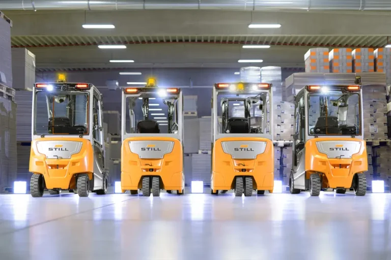 Fleet of construction vehicles parked in service yard