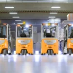 Fleet of construction vehicles parked in service yard